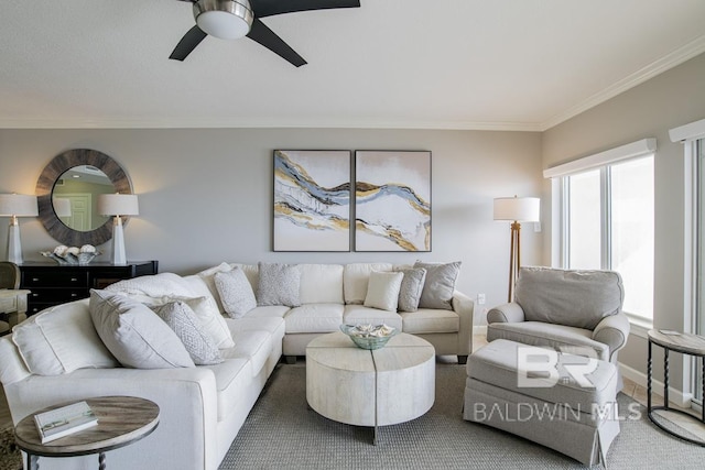 living room with baseboards, ceiling fan, and ornamental molding