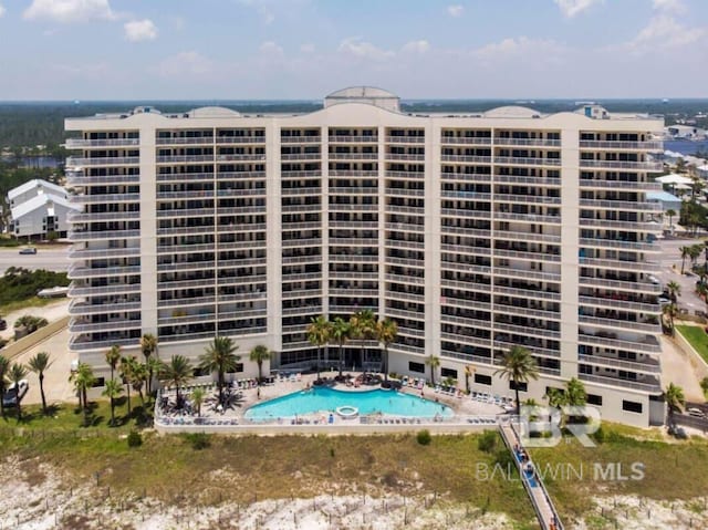 view of building exterior featuring a community pool