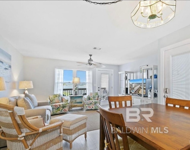 dining room featuring visible vents and ceiling fan with notable chandelier