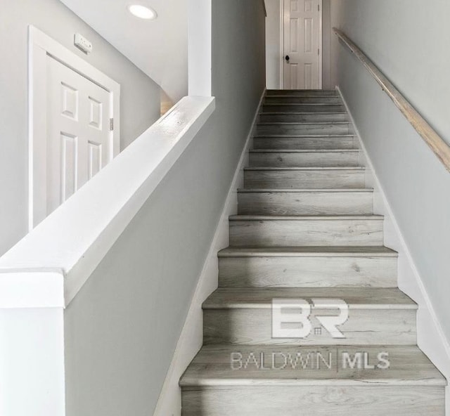 stairway featuring recessed lighting