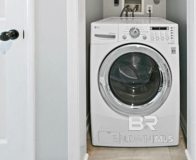 laundry room with laundry area and washer / clothes dryer