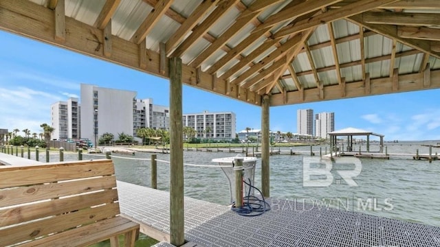 view of dock featuring a view of city and a water view