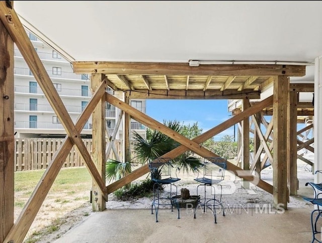 view of gate with a patio area and fence