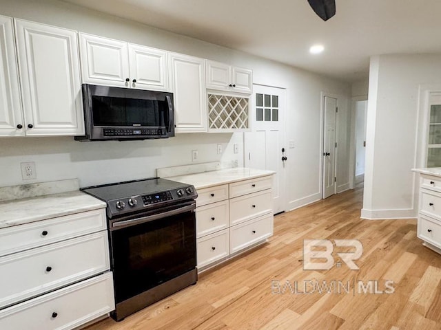 7228 Fairmont Dr, Foley, AL 36535 - kitchen with stainless steel range with electric stovetop, white cabinetry, light wood finished floors, light countertops, and recessed lighting