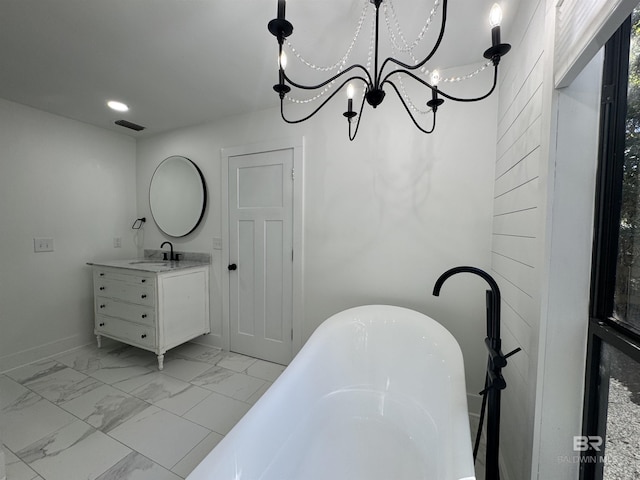 7228 Fairmont Dr, Foley, AL 36535 - bathroom featuring vanity, a freestanding tub, a chandelier, recessed lighting, and marble look tile flooring