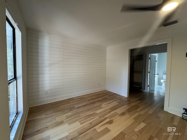 7228 Fairmont Dr, Foley, AL 36535 - unfurnished room featuring light wood-type flooring, baseboards, and wood walls