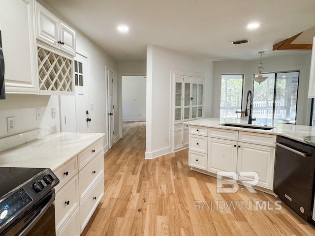7228 Fairmont Dr, Foley, AL 36535 - kitchen featuring black appliances, a sink, white cabinets, light wood finished floors, and recessed lighting