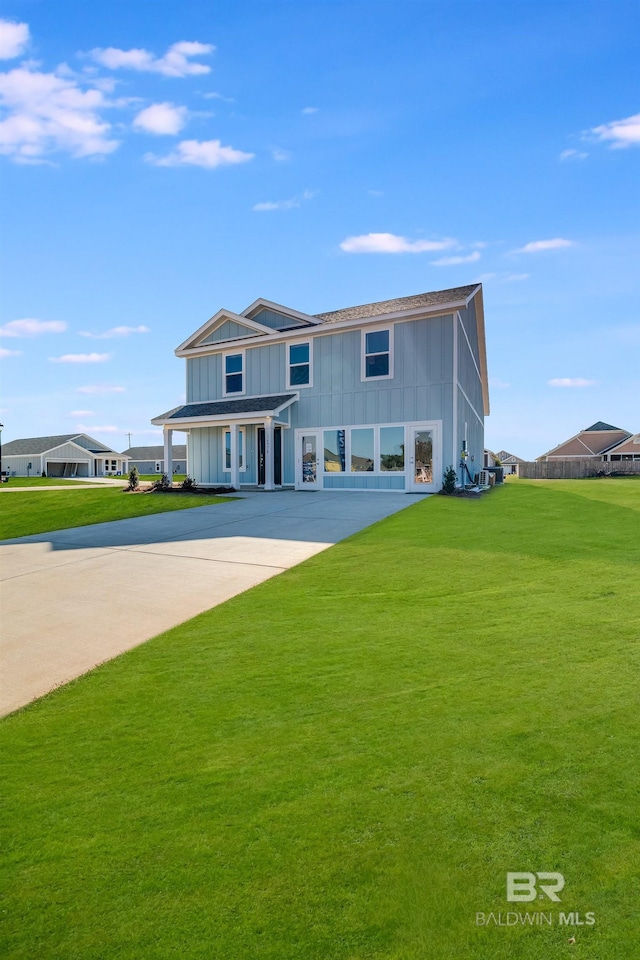 22192 Cesta Way, Silverhill, AL 36576 - view of front facade featuring board and batten siding, a front lawn, and concrete driveway