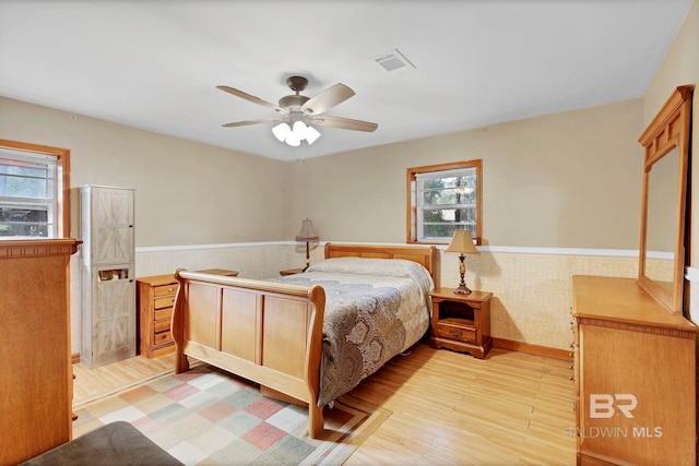 bedroom with ceiling fan and light wood-type flooring