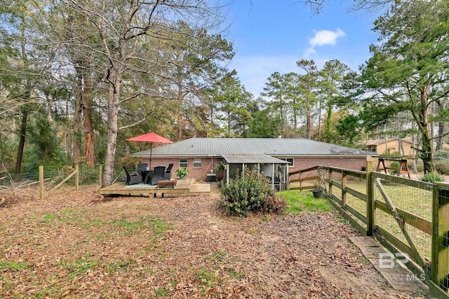 back of house featuring a deck