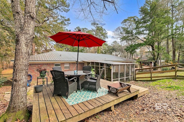 wooden deck featuring a sunroom