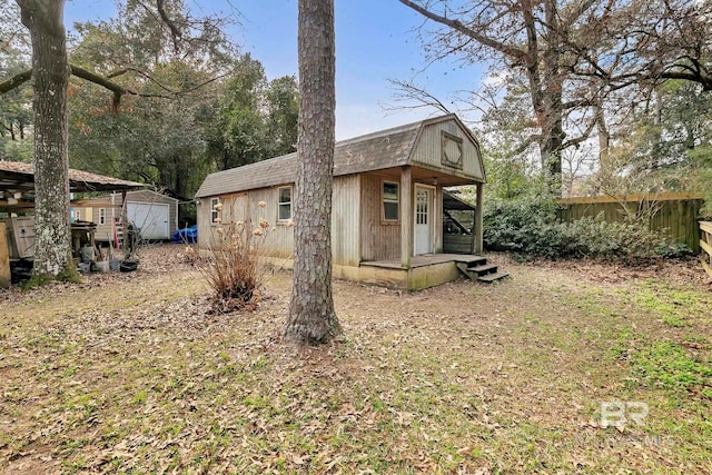 back of house with an outbuilding