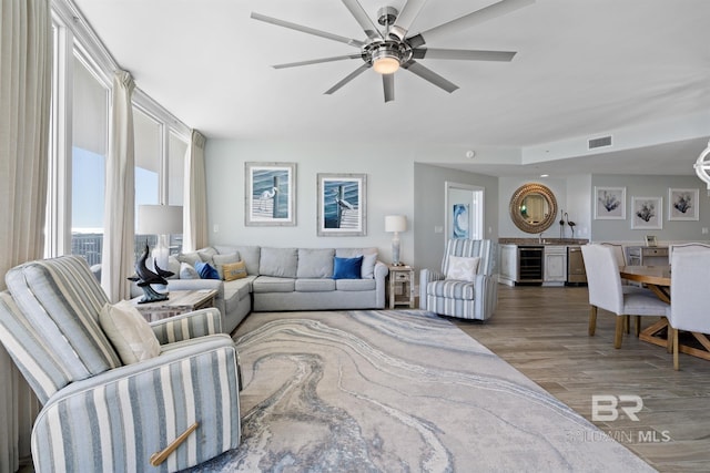28107 Perdido Beach Blvd Unit D512, Orange Beach, AL 36561 - living room featuring beverage cooler, wood finished floors, and a ceiling fan