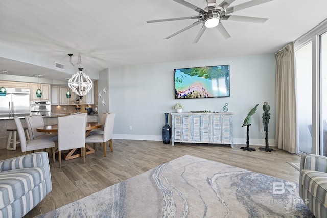 28107 Perdido Beach Blvd Unit D512, Orange Beach, AL 36561 - living room with light wood-style flooring, a ceiling fan, and a chandelier