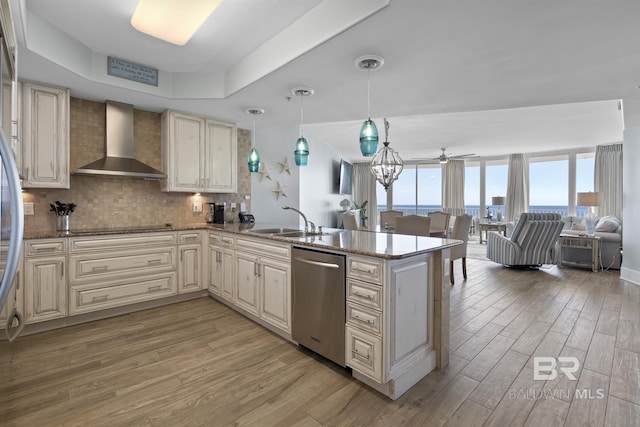 28107 Perdido Beach Blvd Unit D512, Orange Beach, AL 36561 - kitchen featuring dishwasher, wall chimney range hood, light wood-style floors, a peninsula, and ceiling fan