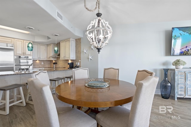 28107 Perdido Beach Blvd Unit D512, Orange Beach, AL 36561 - dining space with light wood finished floors and a chandelier