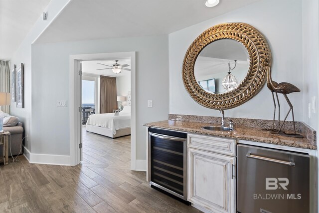 28107 Perdido Beach Blvd Unit D512, Orange Beach, AL 36561 - indoor wet bar featuring beverage cooler, dishwasher, dark wood-style floors, and a ceiling fan