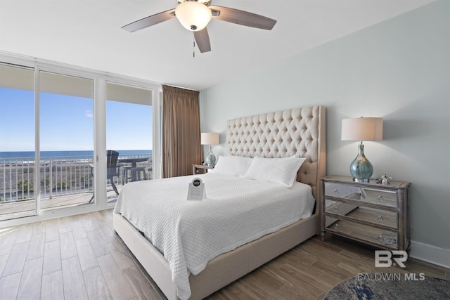 28107 Perdido Beach Blvd Unit D512, Orange Beach, AL 36561 - bedroom featuring floor to ceiling windows, access to exterior, wood finished floors, ceiling fan, and a water view