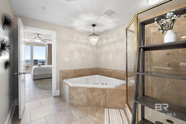 28107 Perdido Beach Blvd Unit D512, Orange Beach, AL 36561 - ensuite bathroom with a jetted tub, a stall shower, a ceiling fan, and tile patterned flooring