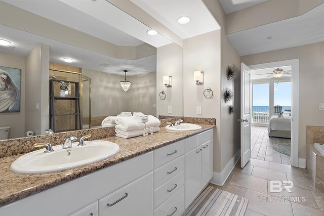 28107 Perdido Beach Blvd Unit D512, Orange Beach, AL 36561 - bathroom featuring connected bathroom, double vanity, a stall shower, a ceiling fan, and recessed lighting