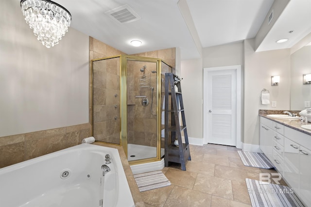 28107 Perdido Beach Blvd Unit D512, Orange Beach, AL 36561 - bathroom featuring double vanity, a tub with jets, a stall shower, and stone tile flooring