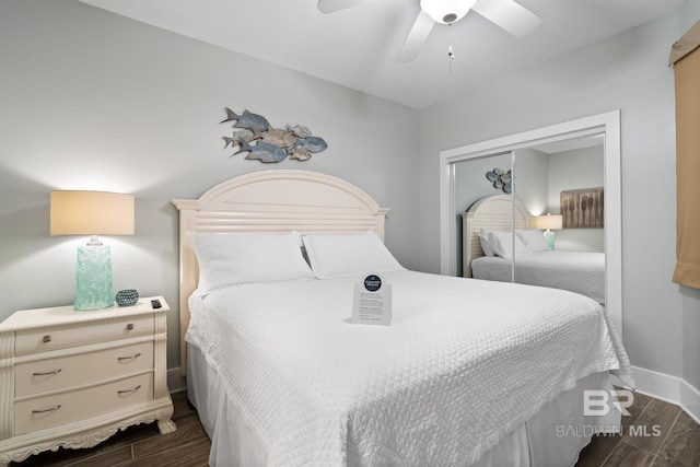 28107 Perdido Beach Blvd Unit D512, Orange Beach, AL 36561 - bedroom with dark wood finished floors, a closet, and a ceiling fan