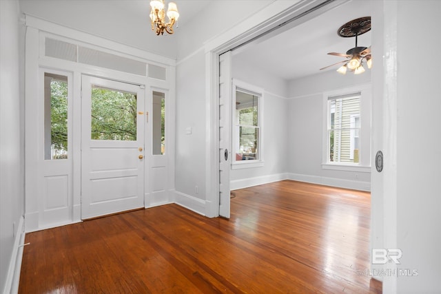 entryway featuring hardwood / wood-style flooring, a healthy amount of sunlight, and ceiling fan with notable chandelier