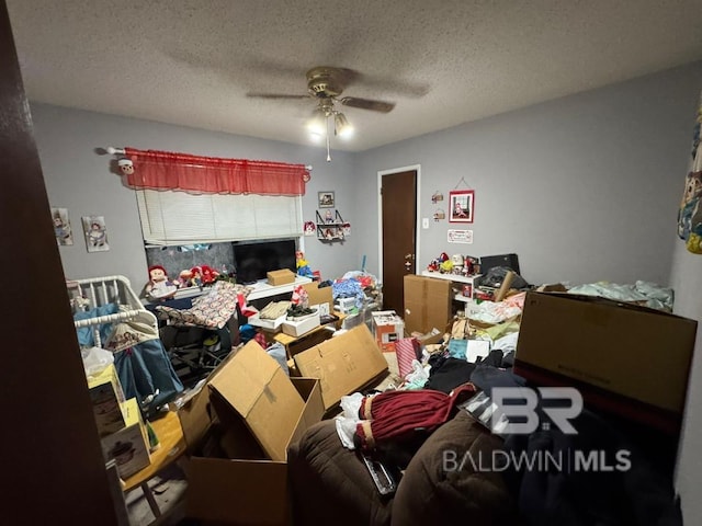 bedroom featuring a ceiling fan and a textured ceiling