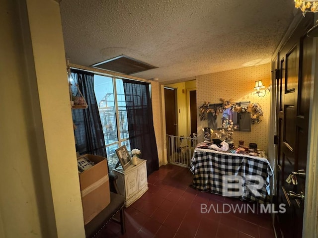 interior space with wallpapered walls and a textured ceiling