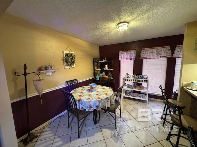 dining room with a textured ceiling and tile patterned floors