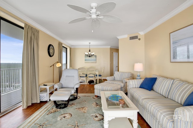 living room with a healthy amount of sunlight, visible vents, dark wood-style flooring, and ornamental molding