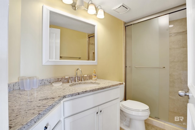 bathroom featuring a shower stall, visible vents, vanity, and toilet