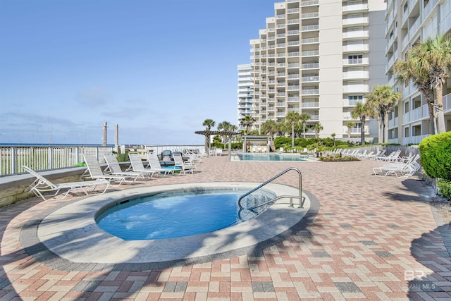 pool with fence and a patio