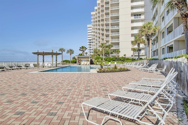 community pool with fence, a patio, and a pergola