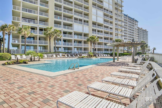 pool with a patio and a pergola