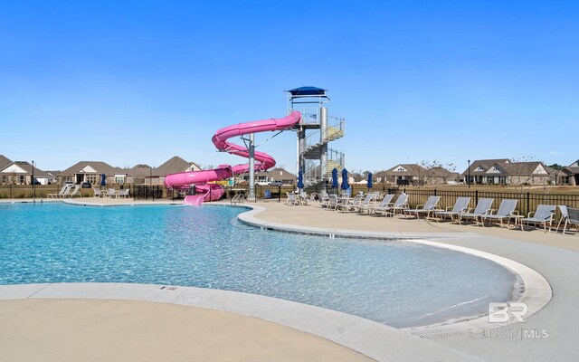 view of swimming pool featuring a patio area and a water slide