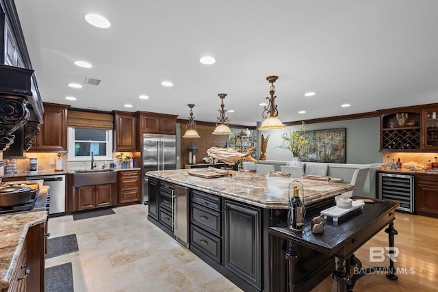 kitchen featuring wine cooler, recessed lighting, tasteful backsplash, a sink, and appliances with stainless steel finishes