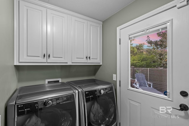 clothes washing area with cabinet space and washing machine and clothes dryer