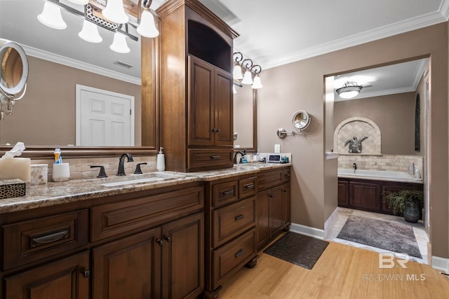 bathroom with crown molding, a sink, wood finished floors, backsplash, and visible vents