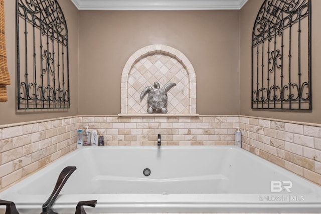 bathroom with ornamental molding and a garden tub