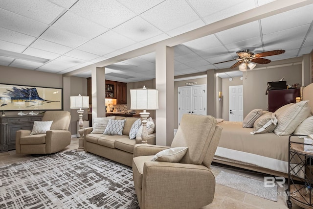 bedroom with a ceiling fan and a drop ceiling