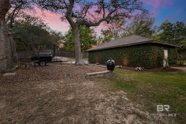 exterior space featuring fence and a lawn