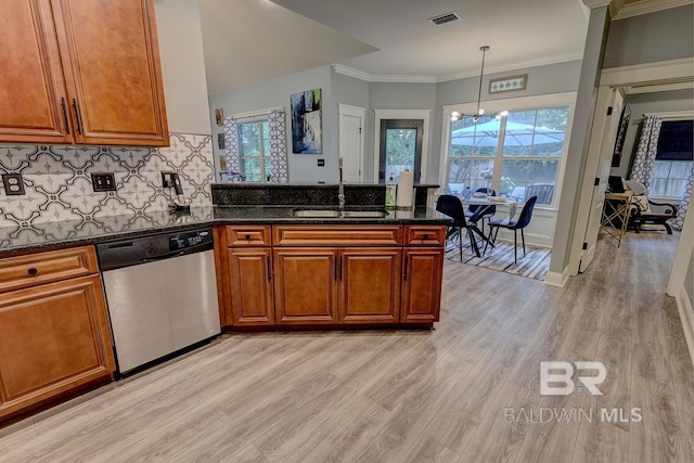 kitchen with decorative light fixtures, dishwasher, light wood-type flooring, dark stone countertops, and sink