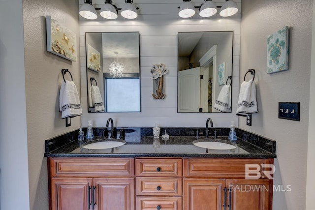 bathroom with large vanity and double sink