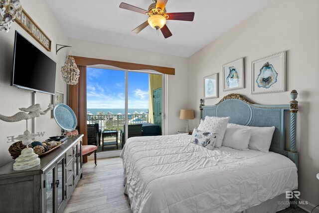 bedroom featuring access to outside, a ceiling fan, and light wood-style flooring