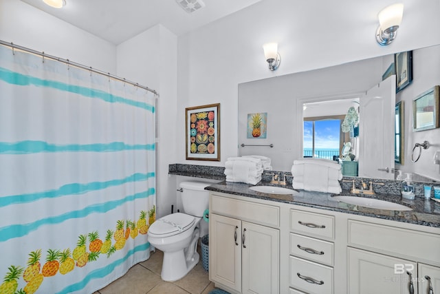 bathroom with visible vents, a sink, tile patterned flooring, and double vanity