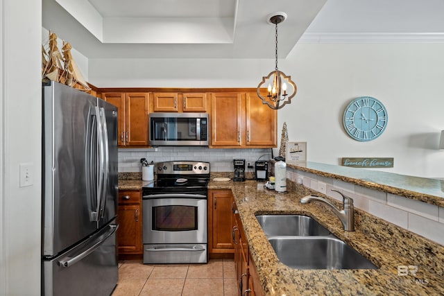 kitchen with decorative backsplash, brown cabinets, a sink, light tile patterned floors, and stainless steel appliances