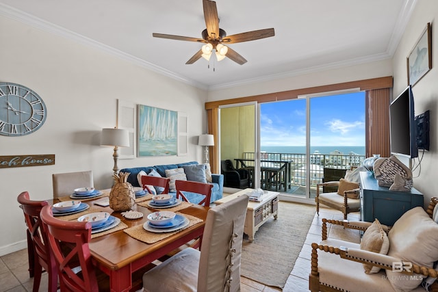 dining area featuring crown molding, a ceiling fan, baseboards, and light tile patterned floors