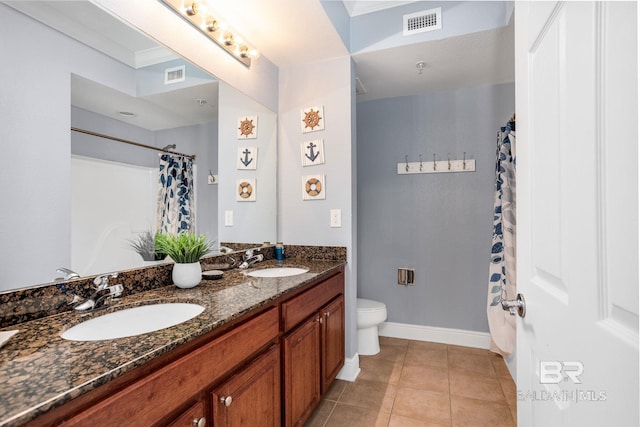 bathroom featuring toilet, tile patterned flooring, a sink, and visible vents