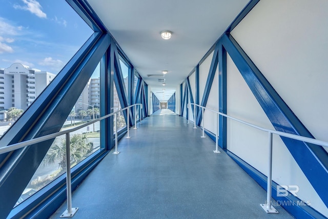 hall with a view of city and floor to ceiling windows